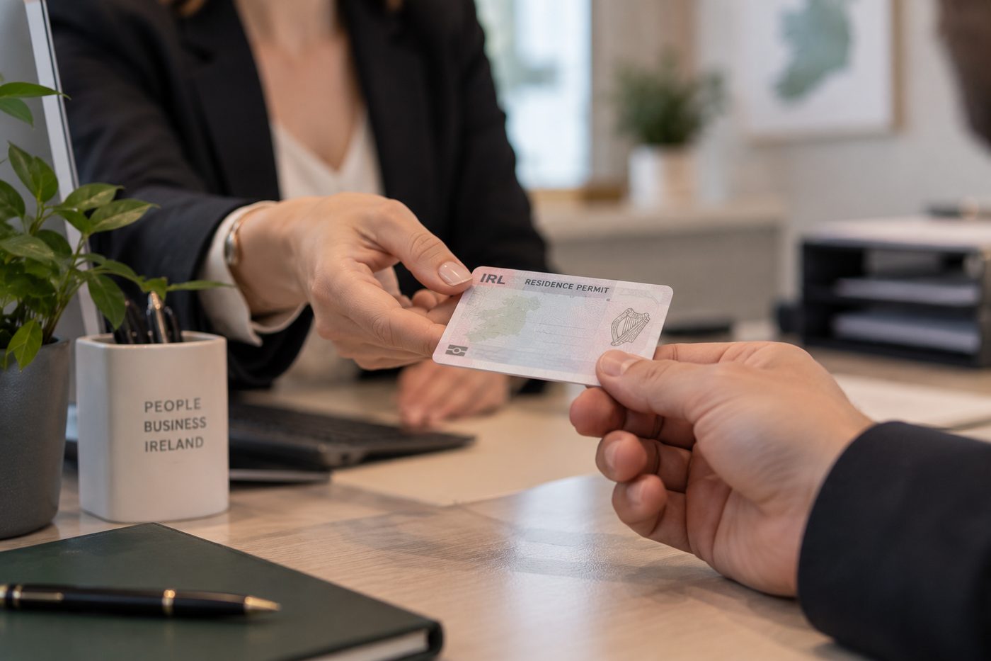 Employer reviewing employment documents and an IRP card before hiring a non-EEA candidate